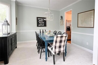 Dining room with a chandelier, crown molding, ligh