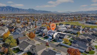 Aerial view of property's location with nearby Elementary schoolw and a mountainous background