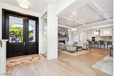 Foyer with a stone fireplace, beamed ceiling, coff