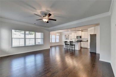 Living room with baseboards, dark wood-style floor