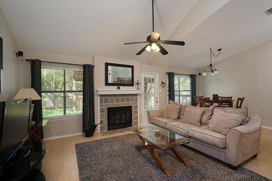 Living room featuring a textured ceiling, a firep