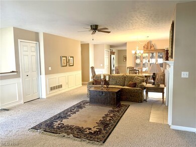 Great room featuring light carpet and ceiling fan