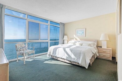 Bedroom with a textured ceiling and carpet