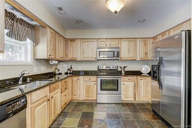 Open concept kitchen with natural wood colored cab