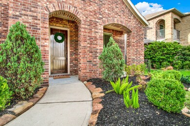 Elegant brick exterior with a welcoming wooden doo