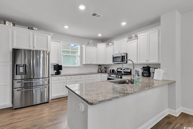 Kitchen with kitchen peninsula, appliances with st