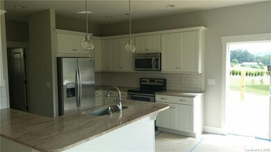 Granite counters & stainless appliances in kitchen