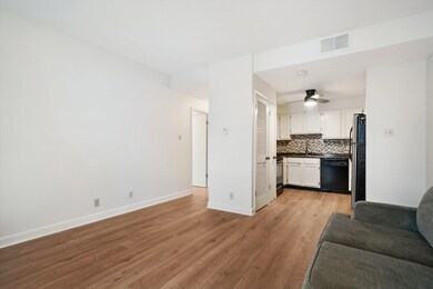 Kitchen with white cabinetry, tasteful backsplash,