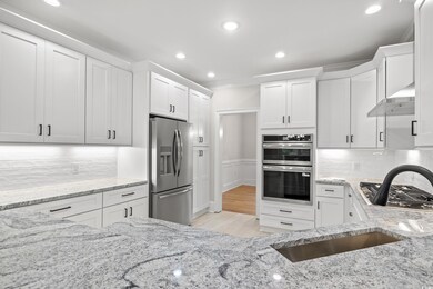 Kitchen with stainless steel appliances, ventilati