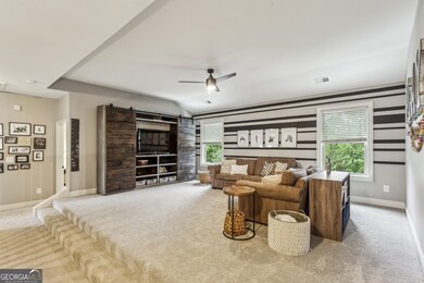 Upstairs, the Lofted Bonus Room is an awesome, flexible space complete with Custom Sliding Wooden Doors, Built-Ins, and room for a TV.