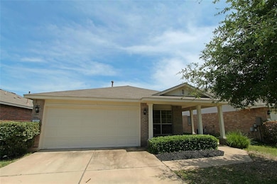 Ranch-style home with driveway, an attached garag