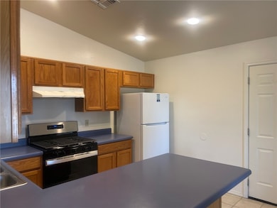 Kitchen with stainless steel gas range, freestandi