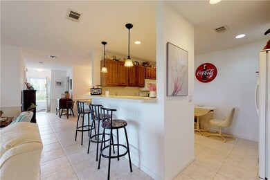Kitchen opens up with bar to living room