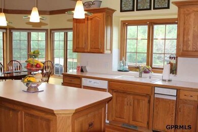 Center Island/ Dishwasher/ Refrigerator/ Double Wall Ovens/ Cook Top/ Gazebo Style eating area/ Planning Area/ Connected to Main Floor Laundry w/ sink & storage