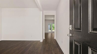 Corridor featuring dark hardwood / wood-style floo