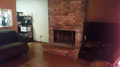 Family room with wood burning fireplace off of kit