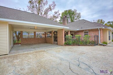 DOUBLE CARPORT SURROUNDED BY WROUGHT IRON FENCING 