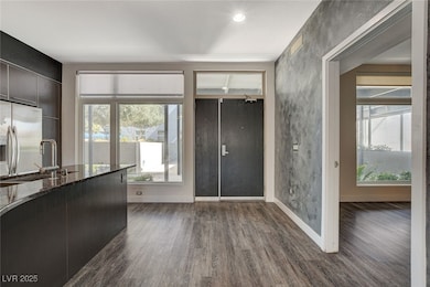 Foyer with dark wood finished floors and recessed lighting