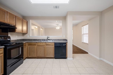 Kitchen with black appliances, under cabinet rang