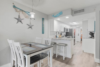 Dining area with visible vents and light wood-style floors