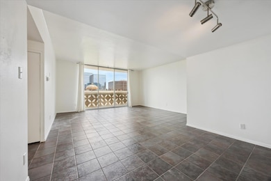 Living room showing Dining / Office / or flex space -  dark tile patterned flooring and a city view