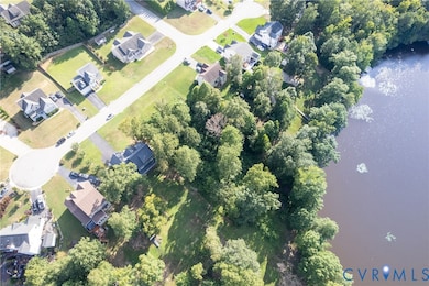 View of property location featuring a nearby body of water and nearby suburban area