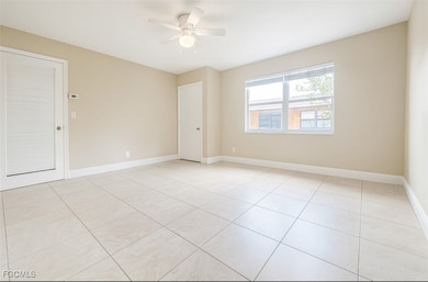 Spare room featuring light tile patterned floors and a ceiling fan