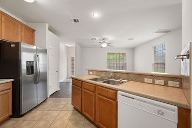 Kitchen with stainless steel fridge, white dishwa