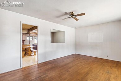 Featuring hardwood flooring and a ceiling fan