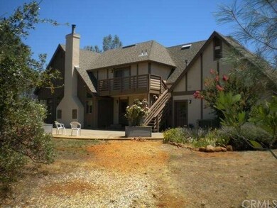 Back of home. shows deck/staircase coming from the