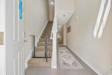 Staircase featuring baseboards