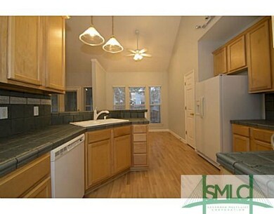Kitchen. Stove, built-in microwave, refrigerator a