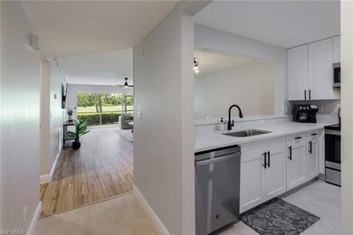 Kitchen with light wood-type flooring, appliances 