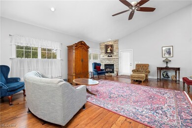 Cherry wood flooring and gas fireplace.