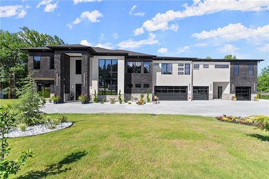View of front of home with stone siding, stucco siding, driveway, and a front yard