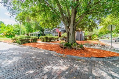 Beatuiful tree lined street with brick road and si