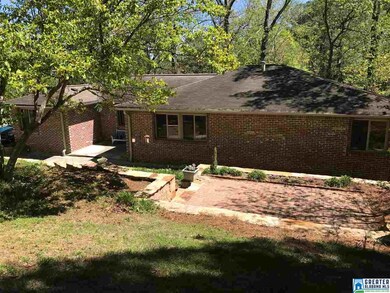 Front yard features a terraced garden with large b