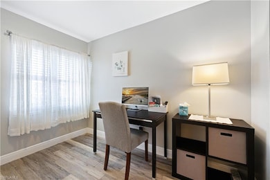 Office space featuring light wood-style flooring and baseboards