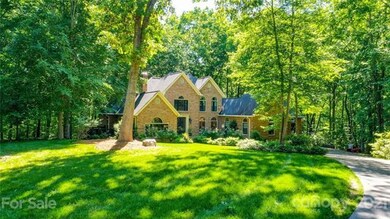 Nestled in the trees, 5' white azaleas line the ri