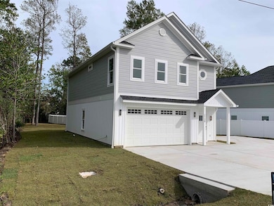 View of front property with a garage and a front y