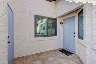 Entrance to property featuring stucco siding