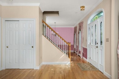 View of coat closet and staircase.