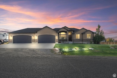 View of front of property with stucco siding, concrete driveway, a garage, and stone siding