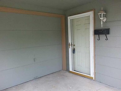 Exterior Front. Front door and 1 car garage.