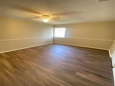 Spare room featuring dark wood-type flooring and c