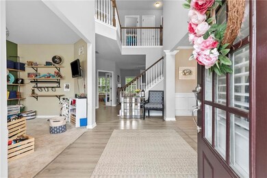 Foyer entrance with baseboards, wainscoting, wood 