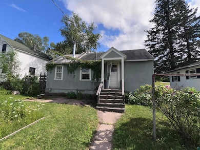 Bungalow-style house with a front lawn