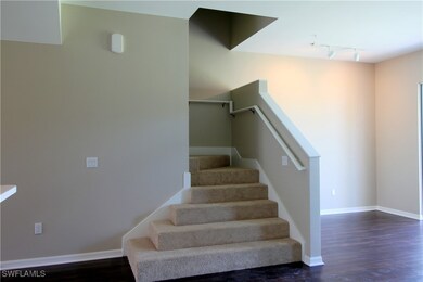Stairway featuring wood finished floors, baseboard