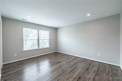 Empty room featuring dark wood-type flooring