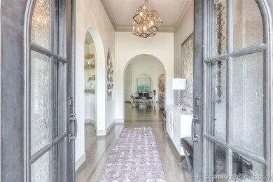 IRON ARCHED DOUBLE DOOR ENTRY WITH ARCHITECTURAL D